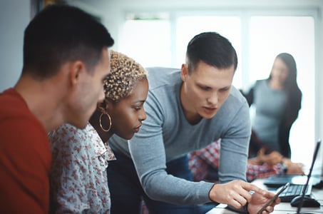 group of people in an office discussing how to convert a website into a mobile app