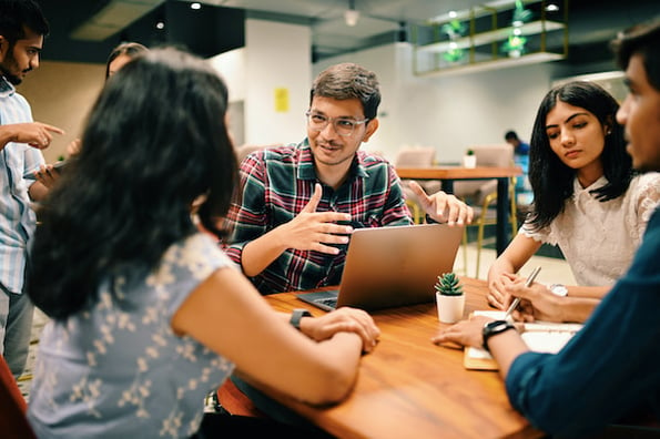 group of UX writiers discussing UX writing in an office